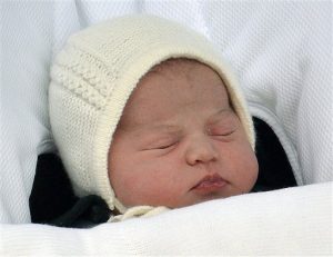 La hija recién nacida de Catalina, la duquesa de Cambridge, y el príncipe Guillermo es llevada en una silla para auto por su padre frente al hospital St. Mary's en Londres en una fotografía del 2 de mayo de 2015. La princesa se llamará Carlota Isabel Diana, se anunció el lunes 4 de mayo. (John Stillwell/Pool via AP, archivo)