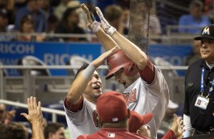 Arizona Diamondbacks'  David Peralta, left, celebrates with A.J. Pollock during the eighth inning of a baseball game against the Miami Marlins in Miami, Tuesday, May 19, 2015, after Pollock hit a go-ahead two-run home run. The Diamondbacks won 4-2. (AP Photo/J Pat Carter)