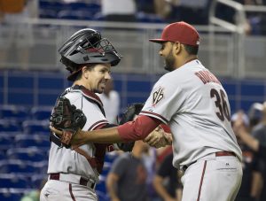 Arizona Diamondbacks catcher Tuffy Gosewisch, left,  and Arizona Diamondbacks relief pitcher Enrique Burgos, right, celebrate after the 13th inning of a baseball game in Miami, Monday, May 18, 2015. The Diamondbacks won 3-2 in the 13th inning. (AP Photo/J Pat Carter)