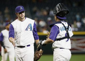 Arizona Diamondbacks relief pitcher Evan Marshall, left, greets catcher Tuffy Gosewisch after a baseball game against the San Diego Padres, Thursday, May 7, 2015, in Phoenix. The Diamondbacks won 11-0. (AP Photo/Matt York)