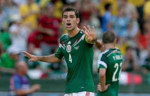 Mexico's Rafael Marquez, left, instructs his teammates after the Netherlands scored their second goal during the World Cup round of 16 soccer match between the Netherlands and Mexico at the Arena Castelao in Fortaleza, Brazil, Sunday, June 29, 2014. (AP Photo/Marcio Jose Sanchez)