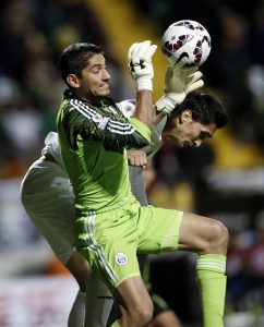 Mexico's goalkeeper Jose de Jesus Corona grabs the ball as Bolivia's Ricardo Pedriel tries a header during a Copa America Group A soccer match at the Sausalito Stadium in Vina del Mar, Chile, Friday, June 12, 2015. (AP Photo/Silvia Izquierdo)