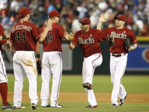 Arizona Diamondbacks left fielder David Peralta and teammates celebrate after defeating the San Diego Padres 7-2 during a baseball game, Sunday, June 21, 2015, in Phoenix. (AP Photo/Rick Scuteri)