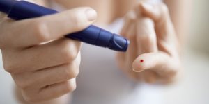 Woman Performing Blood Test on Herself