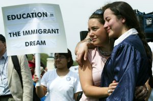 WASHINGTON - APRIL 20:  Ana Maria Archila (R) and Carly Fox, of the New York State Dream Act Task Force, hold each other during a mock graduation ceremony at the West Front of the U.S. Capitol April 20, 2004 in Washington, DC. Several hundred students and advocates took part in the ceremony and urged Congress and the Bush administration to pass the Dream Act, which would put U.S.-raised immigrant students on the path to college and U.S. citizenship.  (Photo by Alex Wong/Getty Images)