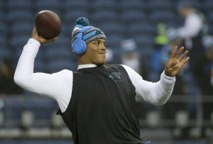 Carolina Panthers quarterback Cam Newton throws before an NFL divisional playoff football game against the Seattle Seahawks in Seattle, Saturday, Jan. 10, 2015. (AP Photo/Elaine Thompson)