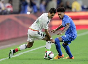 Mexico's Javier Hernandez, left, attempts to take the ball from Honduras' Henry Figueroa (5) during the first half of a soccer match Wednesday, July 1, 2015, in Houston. (AP Photo/Bob Levey)