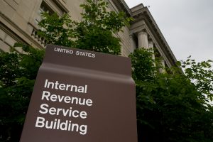 A sign for the Internal Revenue Service (IRS) stands in front of it's headquarters in Washington, D.C., U.S., on Wednesday, May 15, 2013. The widening inquiries into the IRS are focusing less on why employees singled out small-government groups for scrutiny and more on agency executives who didn't inform Congress earlier. Photographer: Andrew Harrer/Bloomberg ORG XMIT: 168943858