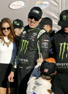 Kyle Busch, top, is congratulated in Victory Lane by fellow driver Daniel Suarez (18) after winning the NASCAR Xfinity Series auto race at Phoenix International Raceway, Saturday, Nov. 14, 2015, in Avondale, Ariz. (AP Photo/Ralph Freso)