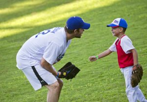 Los Angeles Dodgers pitcher Clayton Kershaw, from the U.S., speaks with a young baseball player during a MBL baseball clinic in Havana, Cuba, Wednesday, Dec. 16, 2015. The three-hour skills camp is part of a three-day mission meant to warm relations between Major League Baseball and Cuba. (AP Photo/Ramon Espinosa)