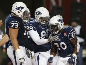 James Butler, corredor de la Universidad de Nevada, celebra con sus compañeros Austin Corbett (73) y Evan Faunce, luego de anotar el touchdown que definió el Arizona Bowl frente a Colorado State. Foto: AP