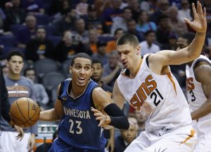 Minnesota Timberwolves' Kevin Martin (23) drives past Phoenix Suns' Alex Len (21), of Ukraine, during the second half of an NBA basketball game Sunday, Dec. 13, 2015 in Phoenix. The Suns defeated the Timberwolves 108-101. (AP Photo/Ross D. Franklin)