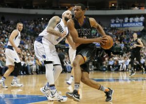 Dallas Mavericks guard Deron Williams (8) defends against a drive to the basket by Phoenix Suns' Sonny Weems (10) in the second half of an NBA basketball game, Monday, Dec. 14, 2015, in Dallas. (AP Photo/Tony Gutierrez)