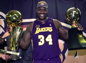 En esta foto de archivo del 15 de junio de 2001, el jugador de los Lakers, Shaquille O'Neal, sostiene el trofeo de campeón y el trofeo de jugador más valioso tras ganar la final de la NBA contra Filadelfia. O'Neal fue elegido el 12 de febrero de 2016, como finalista al Salón de la Fama del básquetbol. (AP Photo/Mark J. Terrill, File)