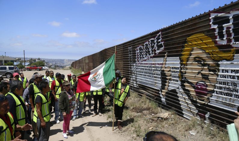 Activistas borran imagen de Donald Trump en muro fronterizo